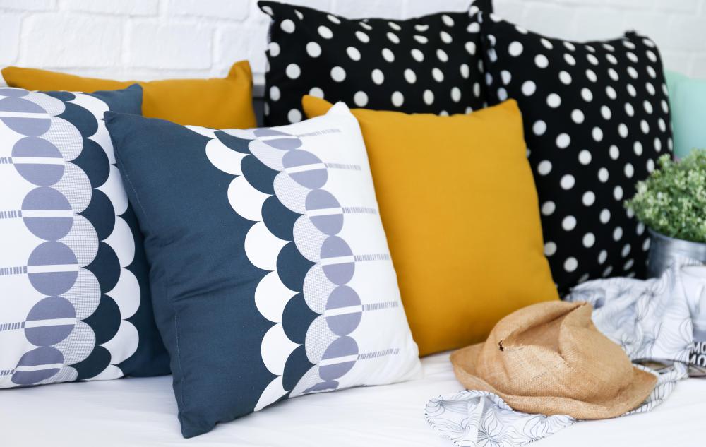 An art deco living room may contain throw pillows featuring geometric shapes.
