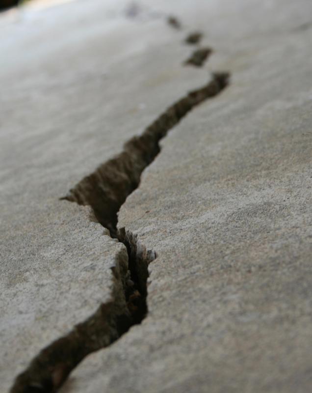 Water may seep into an asphalt surface and cause the asphalt to crack.