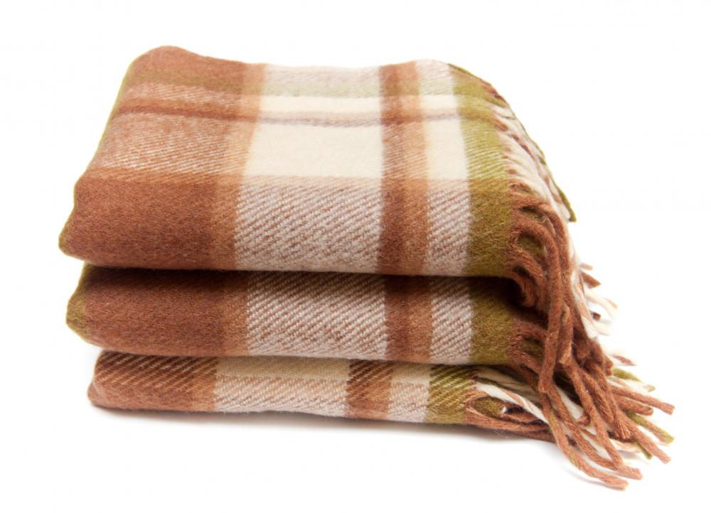 Throw blankets have fringe along the edges.