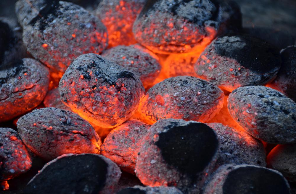 Lighter fluid is often used to help the charcoal catch fire.