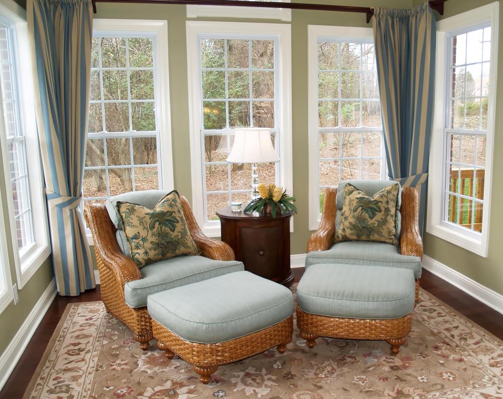 The many windows of a sunroom give the feeling of being outdoors.