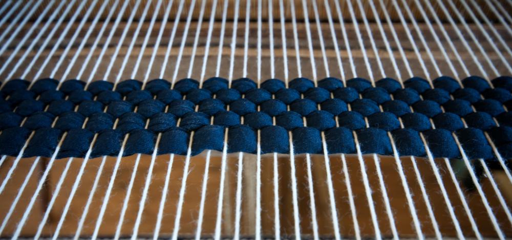 A frame loom helps produce a warp and weft weave.