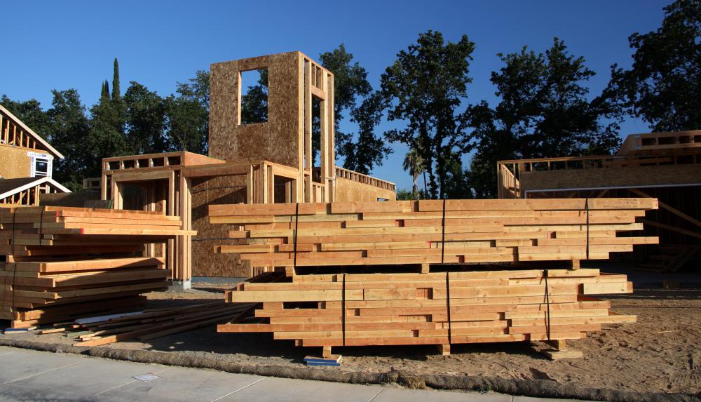 Components of a prefab house are manufactured in an off-site industrial facility.