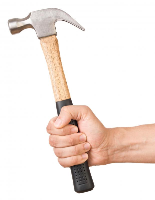 A hammer can be used to tap a lead anchor into a brick wall.