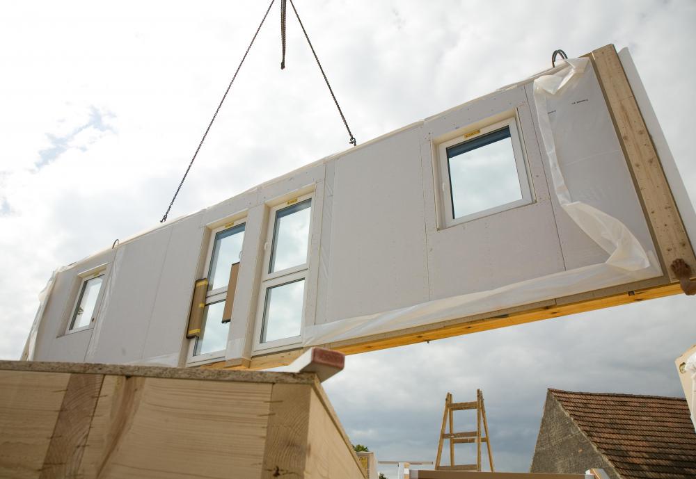 Pieces of a prefab house are shipped to the site where the home will be assembled.