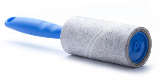 Most lint brushes contain sticky paper tape rolled on a plastic handle.