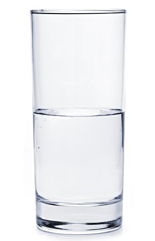 A glass of hard water, which contains calcium and magnesium.