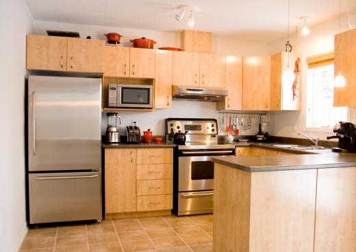 Kitchen with a blender, toaster, kettle, food processor, and espresso machine.