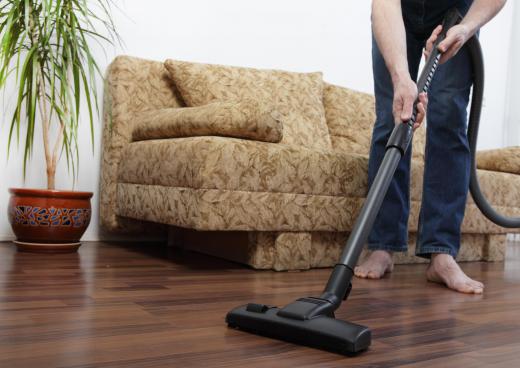 A man using a vacuum cleaner.