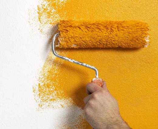 A person painting a basement.