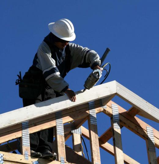 Common rafters are tied together at the base by ceiling joists, which run parallel to the floor.