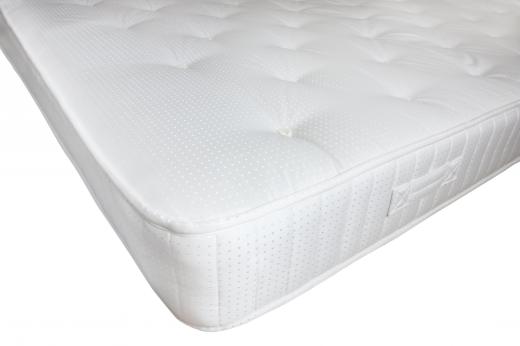 A mattress topper is a soft cushion that sits atop a mattress to provide extra comfort.