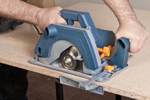 Particle board being cut with a circular saw.