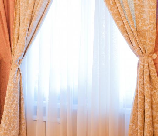 Sheer curtains let light into a room.