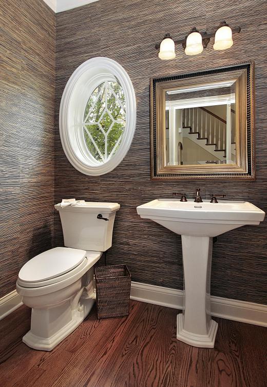 A bathroom with a bar light fixture.