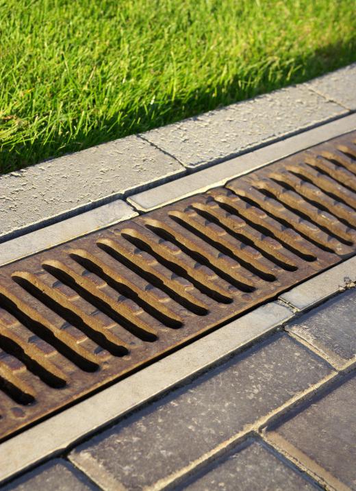 A drainage trench allows water to flow freely into a storm drain.