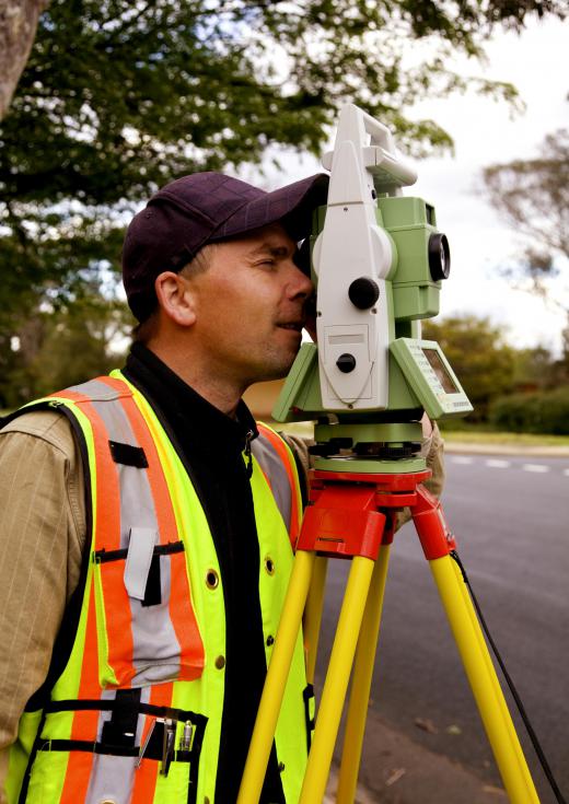 A surveyor using a theodolite to survey a property.