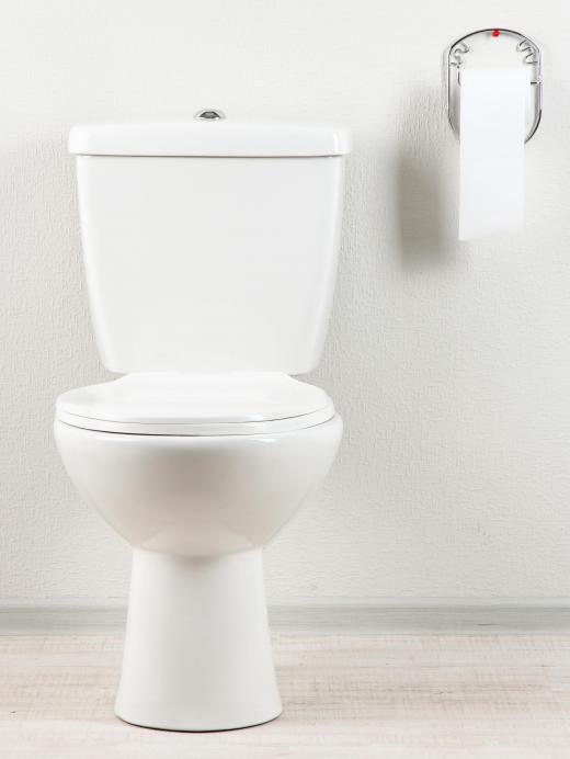 The tank stands above and behind the seat of a modern toilet.