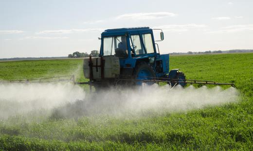 Tractor attachments such as spraying devices prepare the soil with liquid nutrients and pesticides.