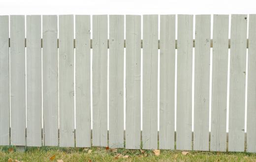 Whitewashed fences can add to the charm of a cottage style house.